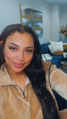 a woman with long black hair is taking a selfie in front of the camera