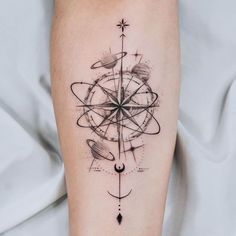 a black and white tattoo design on the right arm, with an arrow in the center