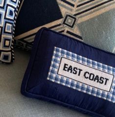 three pillows with the words east coast on them