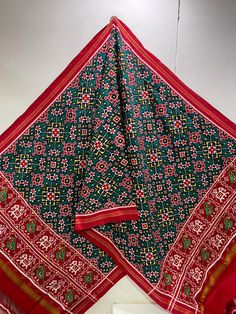 a red and green scarf hanging from the ceiling