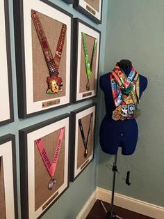 a mannequin is standing in front of a wall with many medals on it