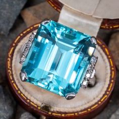 This striking ring is centered with one (1) emerald cut natural aquamarine set into a four-prong setting. The shoulders of the ring are each accented with a row of four (4), bead set, round single cut diamonds. The ring measures 18.6mm at the top, rises 11.5mm above the finger, tapering to 2.5mm wide and 1.8mm thick at the base of the shank. This ring is currently a size 7.75. Aquamarine Stone Ring, Aquamarine Ring Vintage, Find Your Treasure, Aquamarine Cocktail Ring, Blessed Wednesday, Men Rings, Stunning Engagement Ring, Aquamarine Jewelry, Bead Set