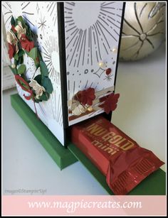 a candy bar sitting on top of a table next to an open card and envelope