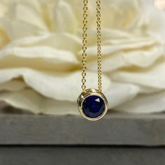 "The pendant pictured is lab created blue sapphire shown in both 14k yellow gold and 14k white gold#5871 The chain is non removable -Approximate total carat weight: approx. .80ctw diamond equivalent -Center Stone Size: 6mm - approx. .80ct diamond equivalent -Center Stone Shape: round -Gem Type: lab created sapphire -Stone Clarity: VS2 -Stone Color: Blue -Moh's Scale: 9 hardness -Metal Type and Purity: 14k white gold -Setting: bezel set floating necklace -Chain: 18\" delicate 14k gold chain / hea Blue Sapphire Pendant, Travel Necklace, Sapphire Necklace Pendants, Floating Necklace, Bezel Necklace, Pear Shaped Engagement Rings, Inspo Pics, Engagement Ring Shapes, White Gold Set