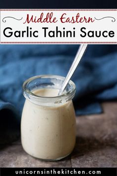 a small glass jar filled with tahini sauce