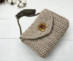 a crocheted purse sitting on top of a white table