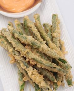 fried green beans with dipping sauce on the side