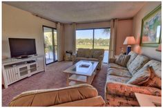 a living room filled with furniture and a flat screen tv