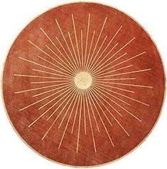 a round wooden table topped with a sunburst design