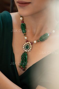 Be the center of attention with this unique and stylish Emerald green necklace. Strung with beautiful jade green stones, pearls, and tourmaline stones, this necklace also showcases a polki encrusted floral pendant adorned with an emerald green stone. Perfect for any occasion, this necklace is sure to make a statement! Closure - Lobster Weight - 92gm Festive Green Necklace With Pearl Pendant, Green Pearl Necklace With Gemstone Beads For Wedding, Green Gemstone Beads Fusion Necklace, Green Fusion Style Gemstone Beads Necklace, Elegant Green Polished Beads, Gems, And Cabochons, Elegant Green Gemstone Beads And Cabochons, Elegant Green Beads For Jewelry Making, Green Gemstone Beaded Necklaces For Wedding, Festive Green Pearl Necklace With Polished Beads