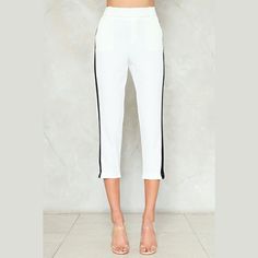 The Take Sides Pants Feature A Cropped, High-Waisted Silhouette, Stripe Detail At Sides, And Elasticized Waist. Fabric: 100% Polyester. Machine Washable, Model Wears Size S. Measurements (Laid Flat): Waist: 15" Hips: 19" In Seam: 23.5" *Small Stain In Front* See Photos White Bottoms For Spring Night Out, White Stretch Pants For Night Out, Chic White Pants For Night Out, Trendy White Pants For Night Out, White Stretch Capris For Work, Elegant White Spring Capris, White Fitted Capris For Summer, Chic White Fitted Capris, White High-waisted Capris For Spring