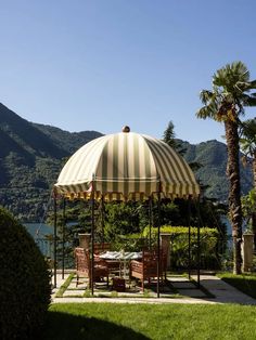 an outdoor gazebo with tables and chairs under it