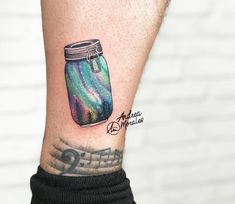 a colorful jar with music notes on the side of his arm and wrist tattoo design