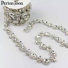 a silver necklace and bracelet set next to a roll of tape with the name perion joon on it