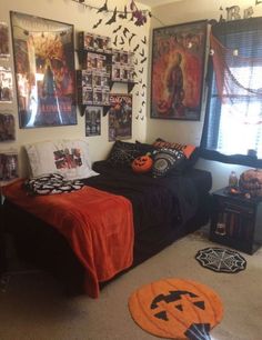 a bedroom decorated for halloween with decorations on the wall and pictures on the walls above the bed