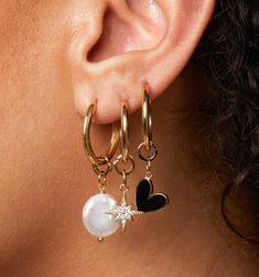 The cutest earring sets that you can mix, match and wear all at once! A charmed life. Wear them many ways to match your vibe for the day. This set comes with two statement pearl charms, a north star charm, and a heart charm.
These gold hoops are for all occasions! Simple, modern, but still statement-making. Our hoops feature a hinged closure, so they are very secure and super easy to put on and off. You can sleep, shower, and hang in them all day long.
Hoop size: 20mm, 2mm widthPearl charms: 14mmHeart charm: 13mmStar charm: 13mm Trendy Dangle Jewelry With Star Charm, Trendy Dangle Pearl Charm Jewelry, Trendy Dangle Jewelry With Pearl Charm, Dangle Pearl Charm, Trendy Everyday Earrings With Pearl Charm, Trendy Pearl Charm Earrings For Gift, Everyday Star Charm Drop Earrings, Trendy Charm Earrings For Everyday, Trendy Dangling Charms Earrings For Everyday