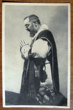 an old black and white photo of a man with a beard wearing a priest's robe