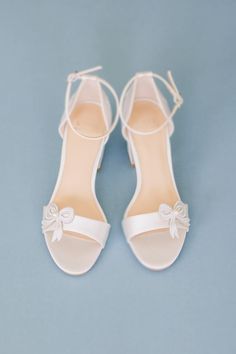 Meet Bleu! We designed the perfect wedding heels for brides who love beauty and comfort! Bleu is made with two and half an inch block heels and amazing pearl and bow details on the finest ivory satin... Did we mention Raya has "I Do" and "Forever" embroidered on the back!!! Wedding Shoes with flat heels with "I Do" and "Forever" embroidery Style “Bleu” in ivory is made with ivory satin 2 1/2" block heel Bow and pearl details Adjustable ankle strap with silver buckle closure for secure fit Vegan Brides Maid Shoes Dusty Blue With Bow, Wedding Heels Gold, Blue Bridal Shoes Block Heel, Blue Wedding Shoes With Heel Strap And Block Heel, Light Blue Ankle Strap Wedding Shoes, Blue Pearl Wedding Shoes, Comfortable Wedding Flats, Bridal Flat Shoes, Lace Wedding Heels