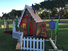 there is a small house made out of fake wood and plastic material in the yard