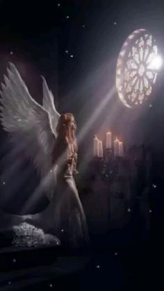 an angel standing in front of a window next to a bed with candles on it