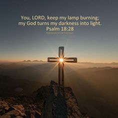 a cross on top of a mountain with the sun shining through it and a bible verse