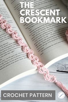 the crescent bookmark crochet pattern is shown on top of an open book