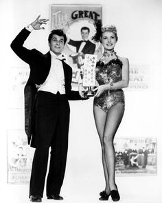 a man in a tuxedo standing next to a woman in a sequined bodysuit