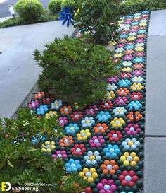 a colorful walkway made out of balls and plants