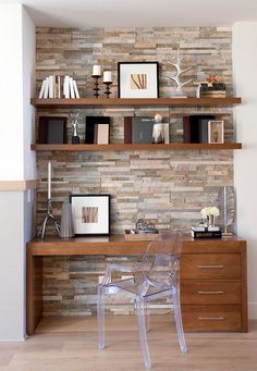 a glass chair sitting on top of a desk in front of a wooden shelf filled with books