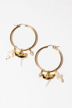 Embellish your summer look with these dainty gold pearl hoops. Sharks are known to be the great rulers of the sea. They are ancient beings believed to symbolize guardianship, knowledge, curiosity, and power. Paired with Keshi pearls, which symbolize wisdom, passion, and bring protection to those who adorn them. ✦ Measure 2.25 inches / 14K GF ✦ Available in Shark Tooth/Keshi Pearls + Shark Tooth/Herkimer Diamonds * Shark teeth will vary slightly in size and shape Designed by Child of Wild Child Of Wild, Surf Jewelry, Shark Tooth, Victorian Rings, Gold Filled Earrings, Keshi Pearls, Special Jewelry, Wild Child, Herkimer Diamond