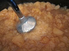 a ladle scooping some food out of the pot