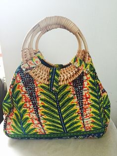 Make a statement with this large stylish bag with gorgeous African print and rustic cane wooden handles fits perfectly with current trends! The bag is very strong and sturdy and fully lined. It has enough room to fit all your everyday essentials and will complete any day or evening outfit. A must-have! Get yours today! Everyday Use Beach Bag With Bamboo Handle, Green Tote Shoulder Bag With Bamboo Handle, Multicolor Tote Bag With Bamboo Handle, Multicolor Tote Shoulder Bag With Bamboo Handle, Green Shoulder Bag With Bamboo Handle For Daily Use, Bohemian Tote Bag With Bamboo Handle, Rectangular Bags With Wooden Handle For Everyday Use, Rectangular Hobo Bag With Bamboo Handle, Rectangular Hobo Bag With Bamboo Handle For Daily Use