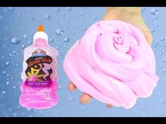 a hand holding a pink soap next to a bottle of liquid