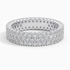 a white gold ring with rows of round diamonds