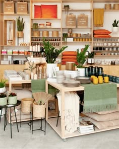 the interior of a store with lots of items on shelves and tables in front of them