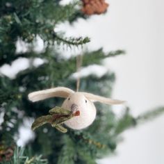 an ornament hanging from the top of a christmas tree