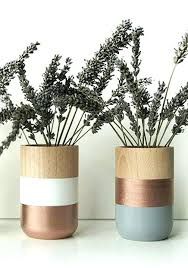 three vases with plants in them sitting on a table