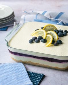 a cake with lemon slices and blueberries on top