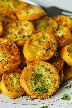 a white plate topped with fried potatoes covered in parsley