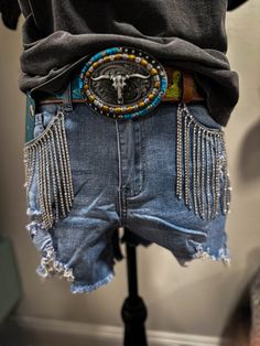 Jump Into Style With These One-of-a-kind Aldean's Denim Rhinestone Shorts! These High-waisted Denim Cut-offs Feature Classic Pockets And a Playful Fringe Tassel Embellished With Sparkling Rhinestones. Each Gem Is Carefully Handcrafted And Stitched For An Extra Touch Of Glam. Don't Risk The Bling By Tossing These In The Wash - They're Dry Clean Only!



Stretchy, But Fits True To Size. Model Is 5'4 Wearing a Small.

Care:


Dry Clean Only!!
You Cannot Put These In The Wash/dryer! 
Do Not Bleach High Waist Bottoms With Frayed Hem For Festival, Trendy Medium Wash Festival Bottoms, Festival Denim Blue Bottoms, Festival Shorts With Frayed Hem, Dark Wash Denim Bottoms For Rodeo, Frayed Hem Festival Shorts, Festival Medium Wash Denim Bottoms, Festival Dark Wash Denim Bottoms, Western Style Medium Wash Mid-rise Bottoms