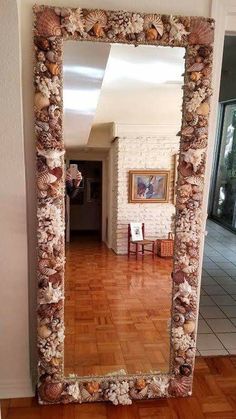 a large mirror sitting on top of a wooden floor