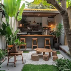 an outdoor bar with stools and tables in the grass next to some potted plants