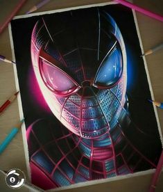 a spiderman drawing with colored pencils on the table