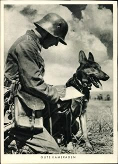 a man sitting next to a dog on top of a field