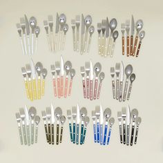 a group of forks and spoons with different colors