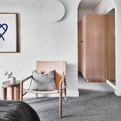 a bedroom with white brick walls and grey carpet