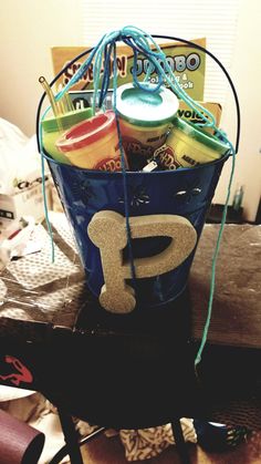 a blue bucket filled with lots of different items