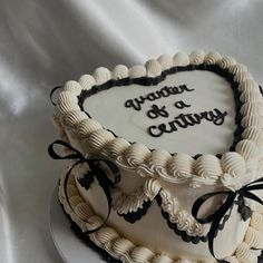 a heart - shaped cake with the words, another of a century on it sits on a plate