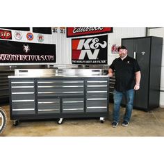 a man standing next to a tool cabinet in a garage