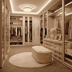 an elegant walk in closet with white furniture